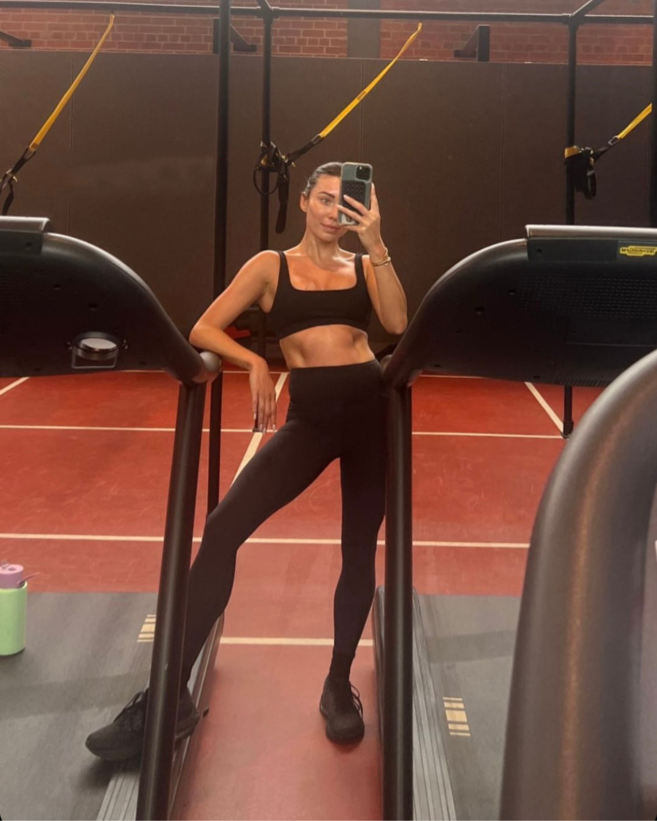 Rozalia Russian standing at a treadmill doing a selfie in Tully Lou activewear black leggings