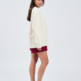 right side view of butter yellow long sleeve top with burgundy shorts