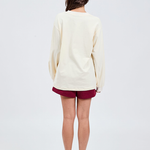 back view of butter yellow long sleeve top with burgundy shorts 