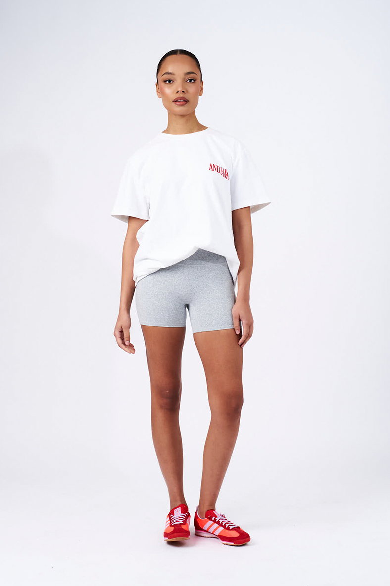 grey bikes shorts styled with white tee and red logo saying andiamo