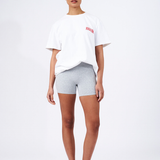 grey bikes shorts styled with white tee and red logo saying andiamo