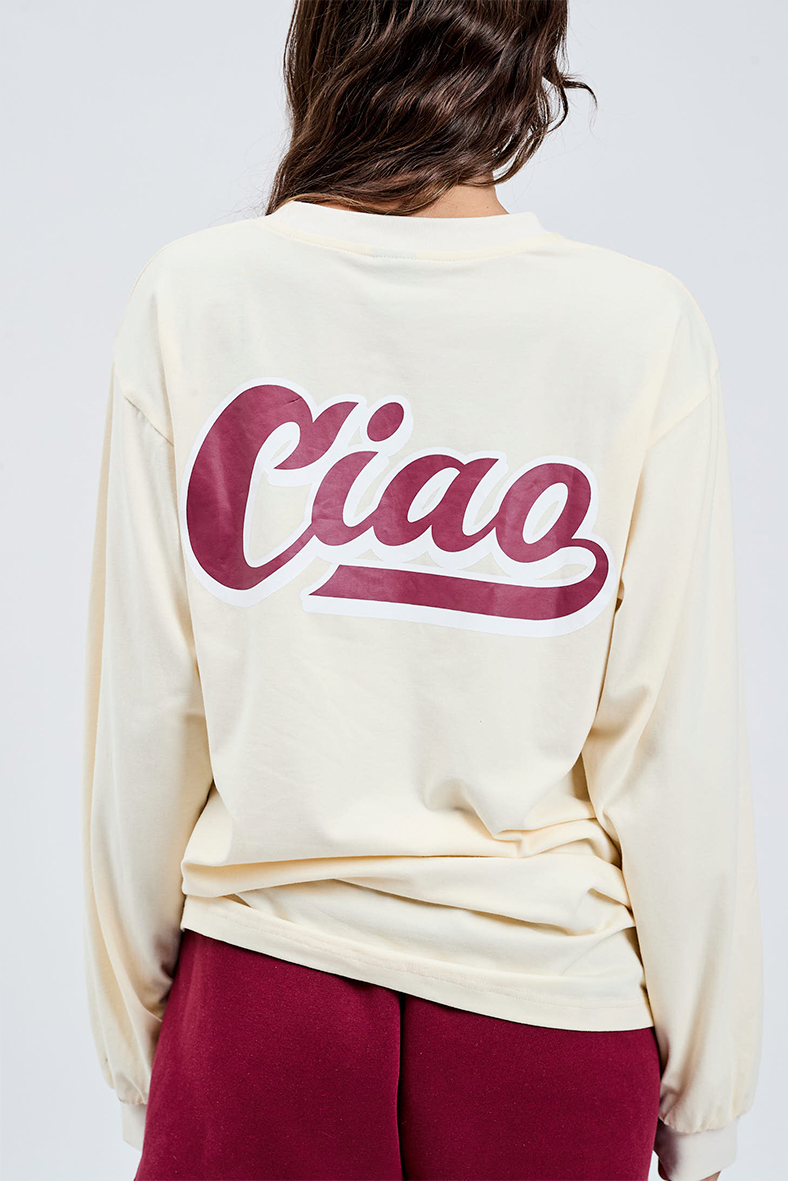 close up of butter yellow long sleeve crew t-shirt with burgundy printed ciao