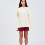 front view of butter yellow long sleeve top with burgundy italic embroidery Tully Lou left side of chest with burgundy shorts