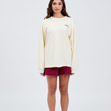 front view of butter yellow long sleeve top with burgundy italic embroidery Tully Lou left side of chest with burgundy shorts