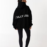 Back design of Tully Lou logo black heavy weight cotton fleece hoodie with black leggings