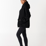 Side image left of Tully Lou black essentials hoodie with black Tully Lou leggings