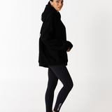 side right picture of Black essentials hoodie with Tully Lou black activewear leggings