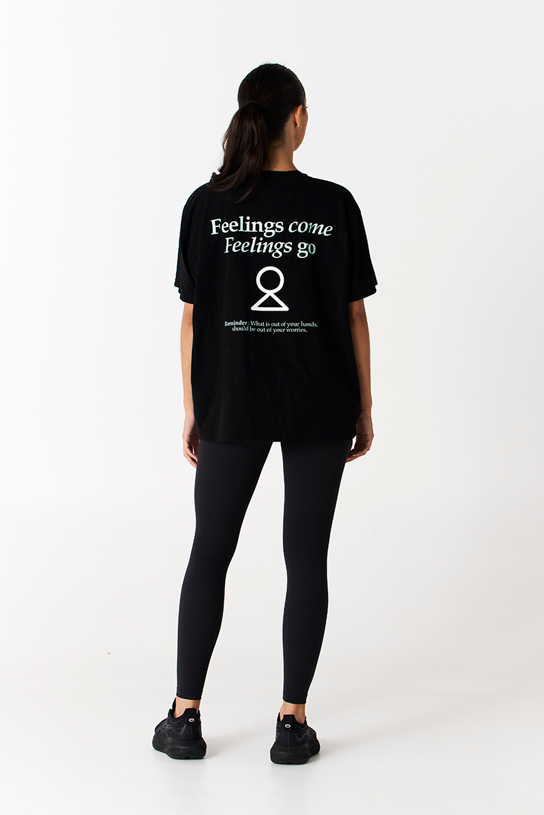 black t-shirt with printed logo about feelings come and feelings go with balance symbol 