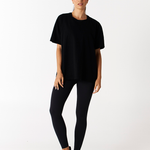 front view of heavy weight black cotton tee with print logo on back and black wide waistband compression leggings Tully Lou