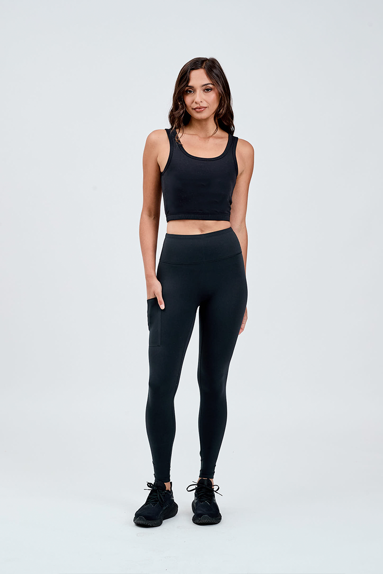 front view black wide waistband leggings with hand in invisible bonded pocket