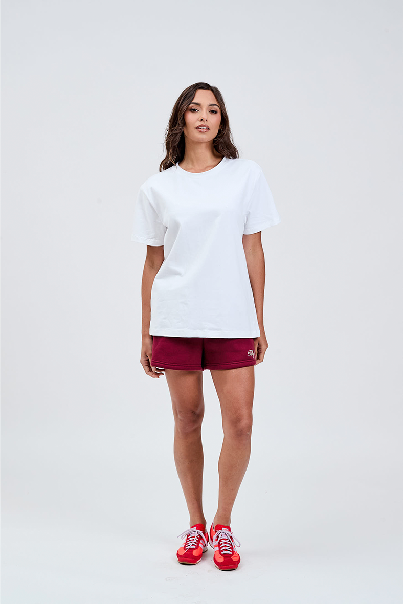 White essential tee styled with burgundy bike shorts