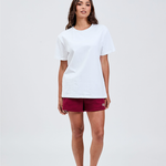 White essential tee styled with burgundy bike shorts