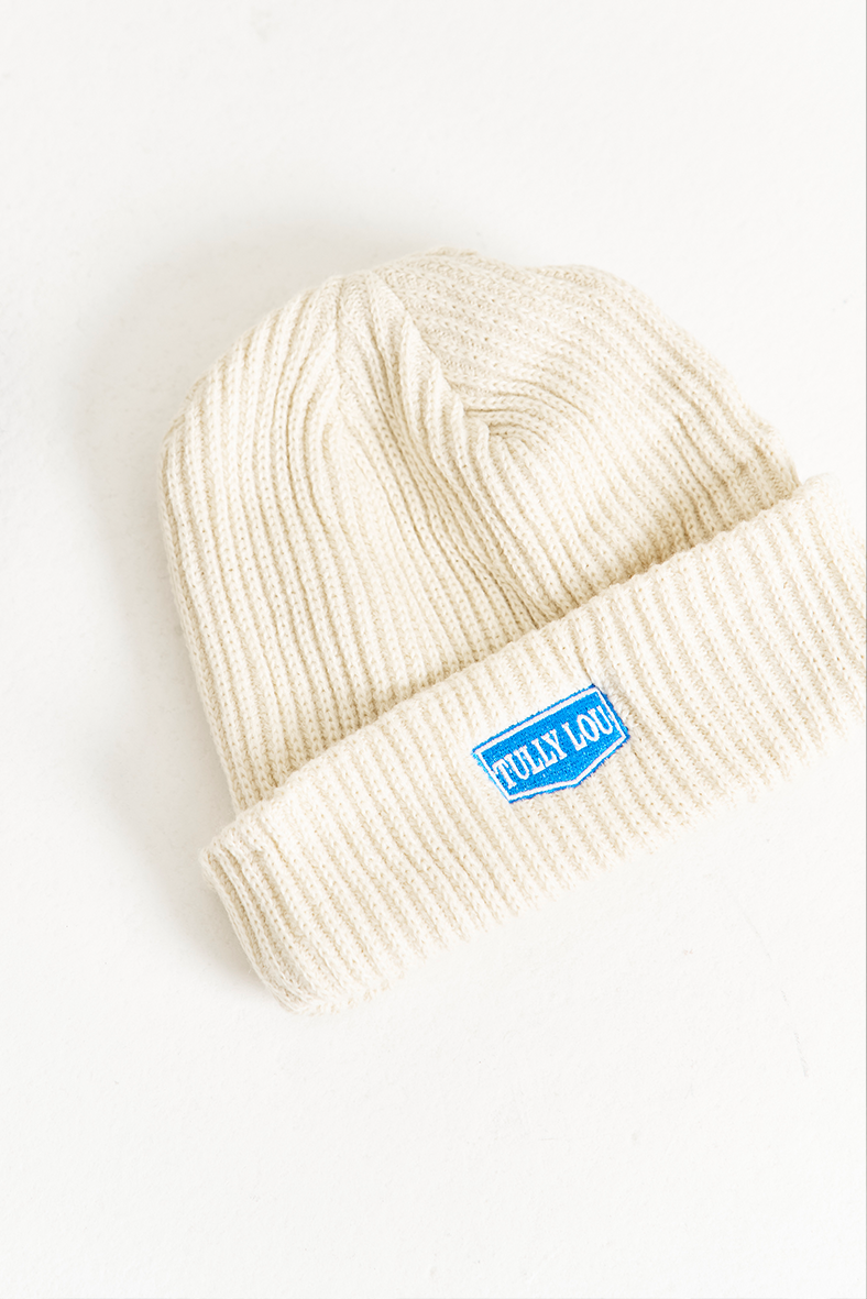white wool beanie with blue tully lou text logo 