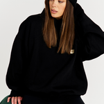 Black beanie with black round neck jumper and black leggings 