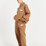 side left image model wearing mocha brown high neck cotton fleece jumper and matching track pants 