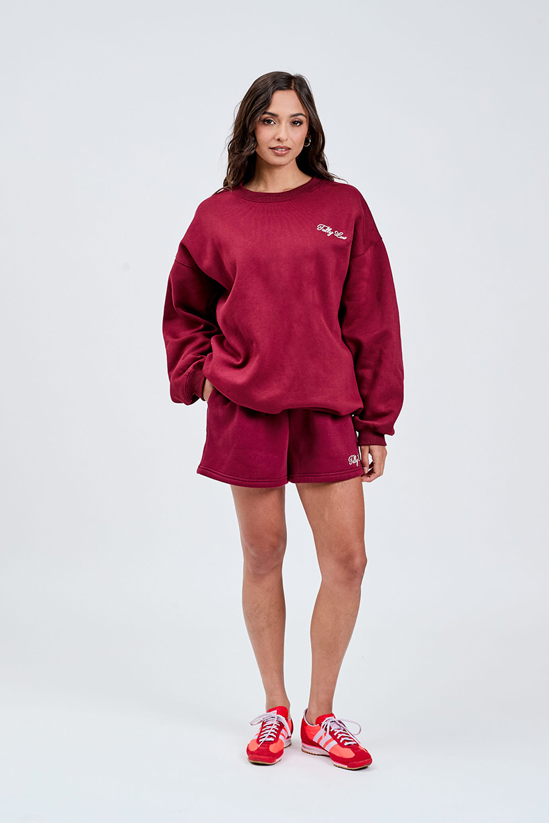 Burgundy crewneck cotton jumper with cream tully lou logo embroidered with matching burgundy shorts 