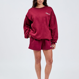 Burgundy crewneck cotton jumper with cream tully lou logo embroidered with matching burgundy shorts 