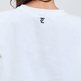 back close up of essential white tee with TL logo embroidered black 