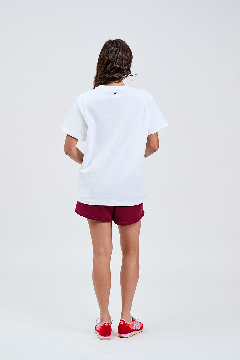 white essential tee back with TL embroidered logo in burgundy top of collar styled with burgundy cotton shorts 