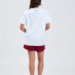 white essential tee back with TL embroidered logo in burgundy top of collar styled with burgundy cotton shorts 