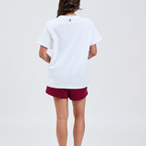 white essential tee back with TL embroidered logo in burgundy top of collar styled with burgundy cotton shorts 