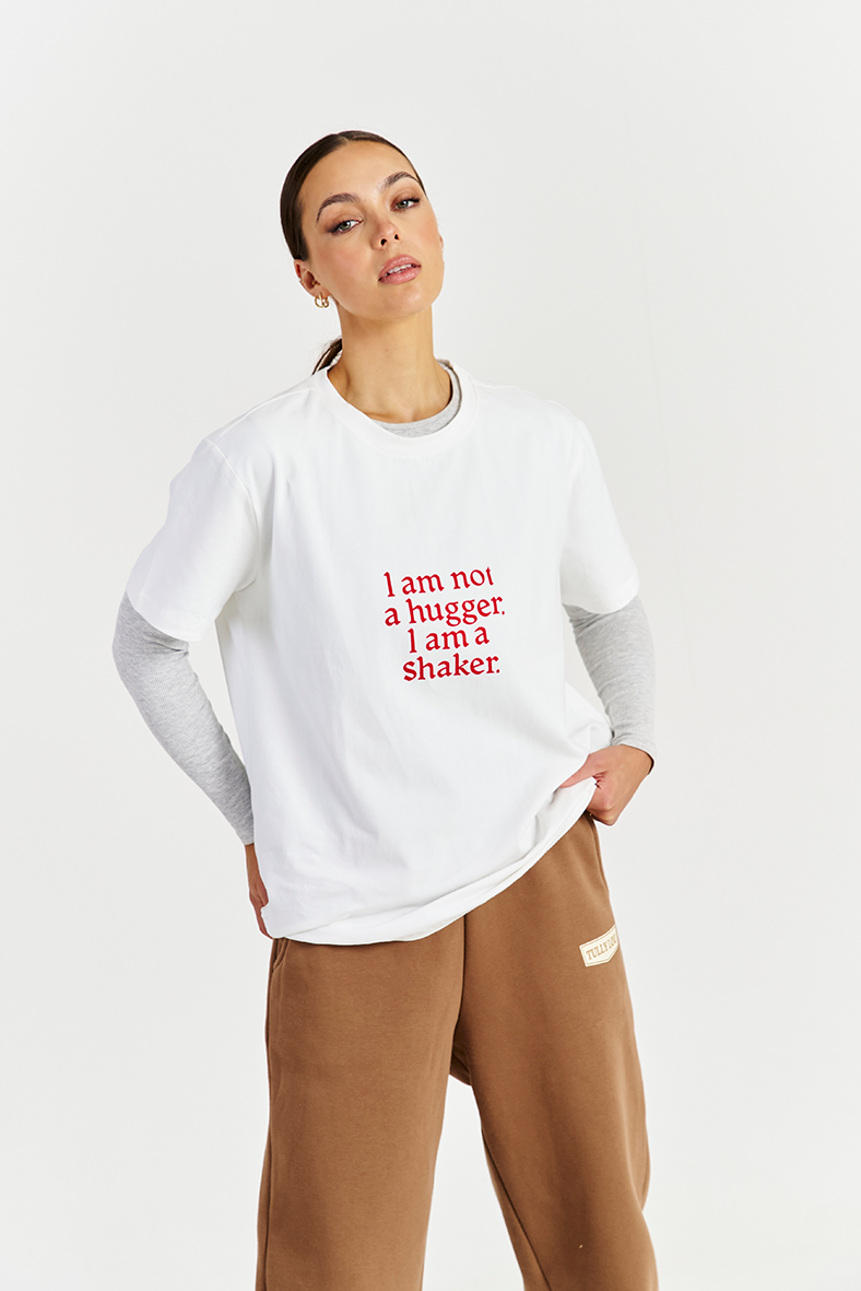 white heavy cotton tee layered with greay long sleeve and brown track pants 