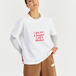 white heavy cotton tee layered with greay long sleeve and brown track pants 