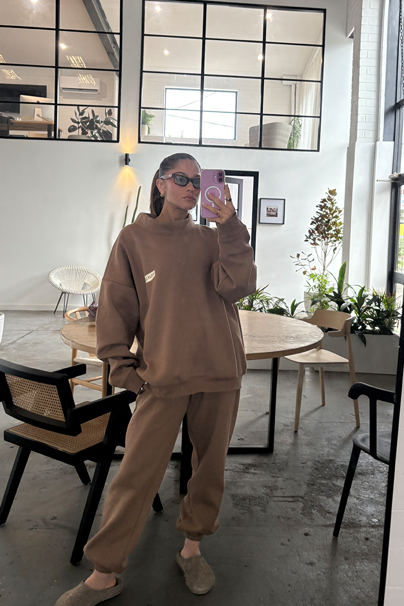 designer tully humphrey taking selfie in mirror with mocha brown tracksuit set on 