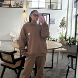 designer tully humphrey taking selfie in mirror with mocha brown tracksuit set on 