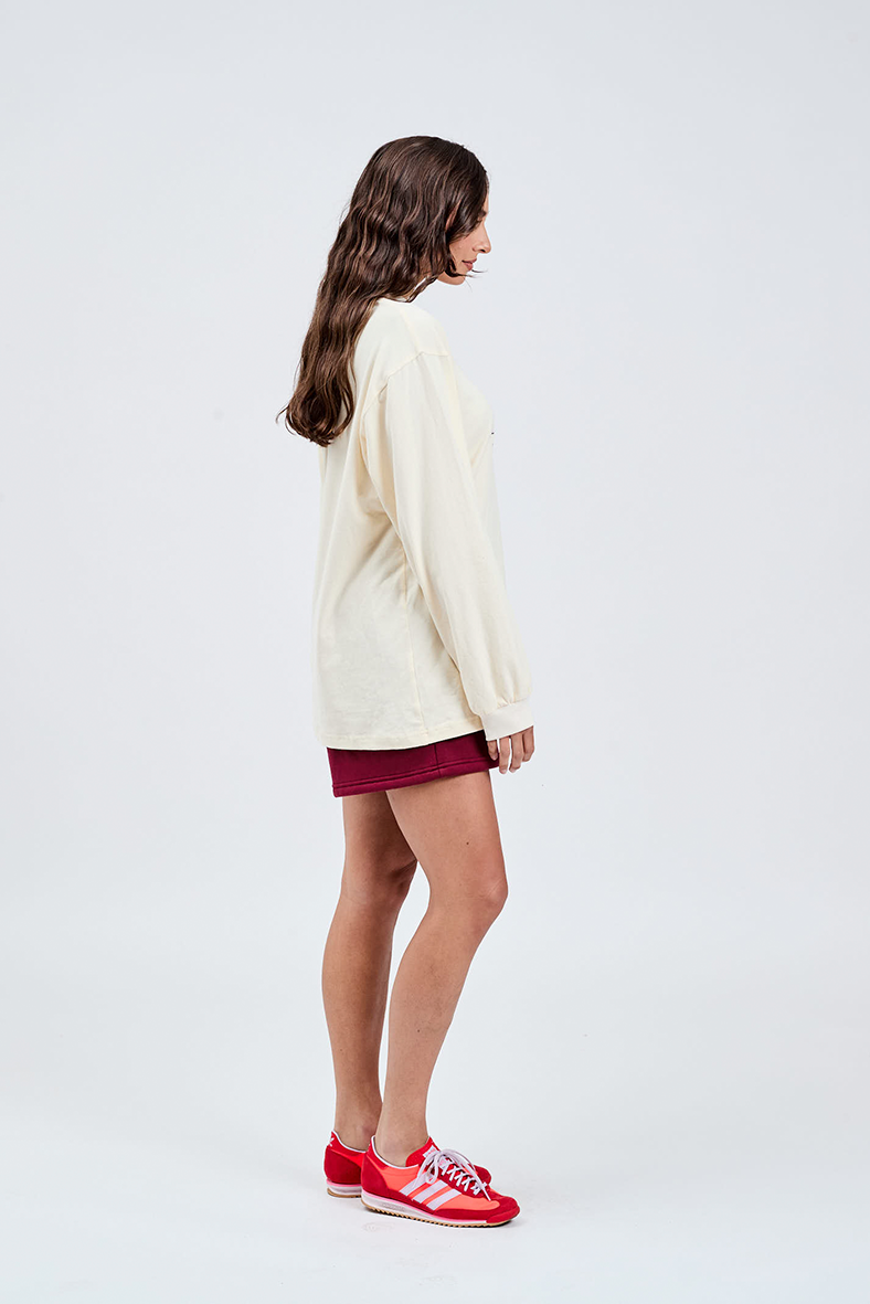 right side view of butter yellow long sleeve cotton top with burgundy shorts