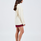 right side view of butter yellow long sleeve cotton top with burgundy shorts