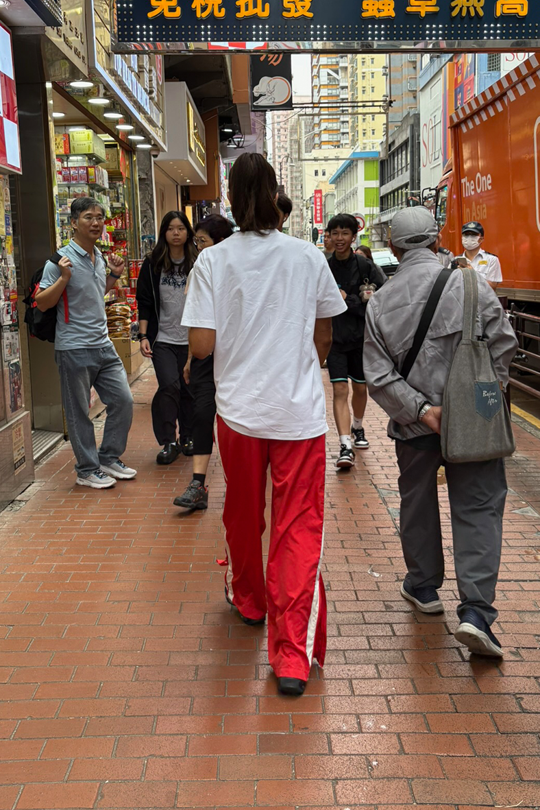 red track pants with people walking in hong kong