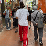 red track pants with people walking in hong kong