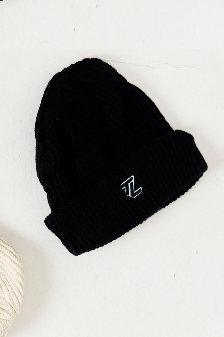 black beanie flat lay image with TL embroidered logo