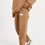 close up side image of mocha brown track pants with left hand side pocket and Tully Lou logo 