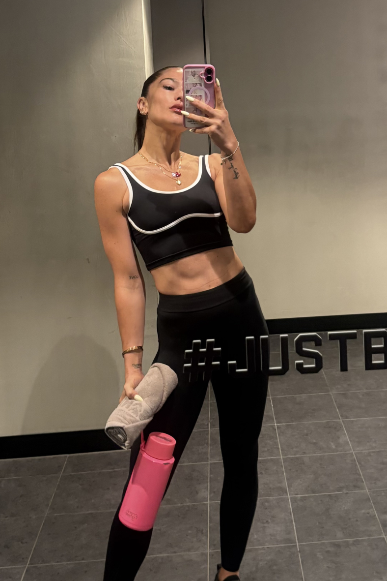 Contrast white piping detail on black sculpted activewear crop selfie in barrys gym